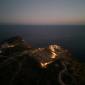 Classical Greek architecture and Mediterranean sunset representing the Golden Age of Greece investment opportunities by Mozaik Investments.